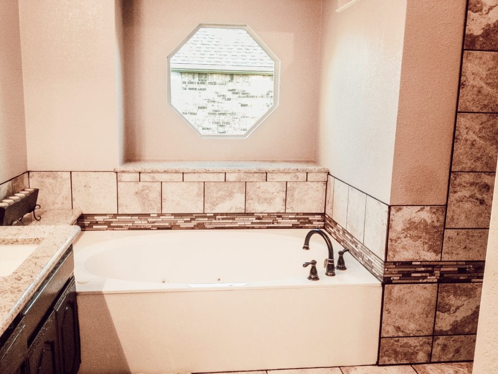 octagonal window over remodeled bathtub