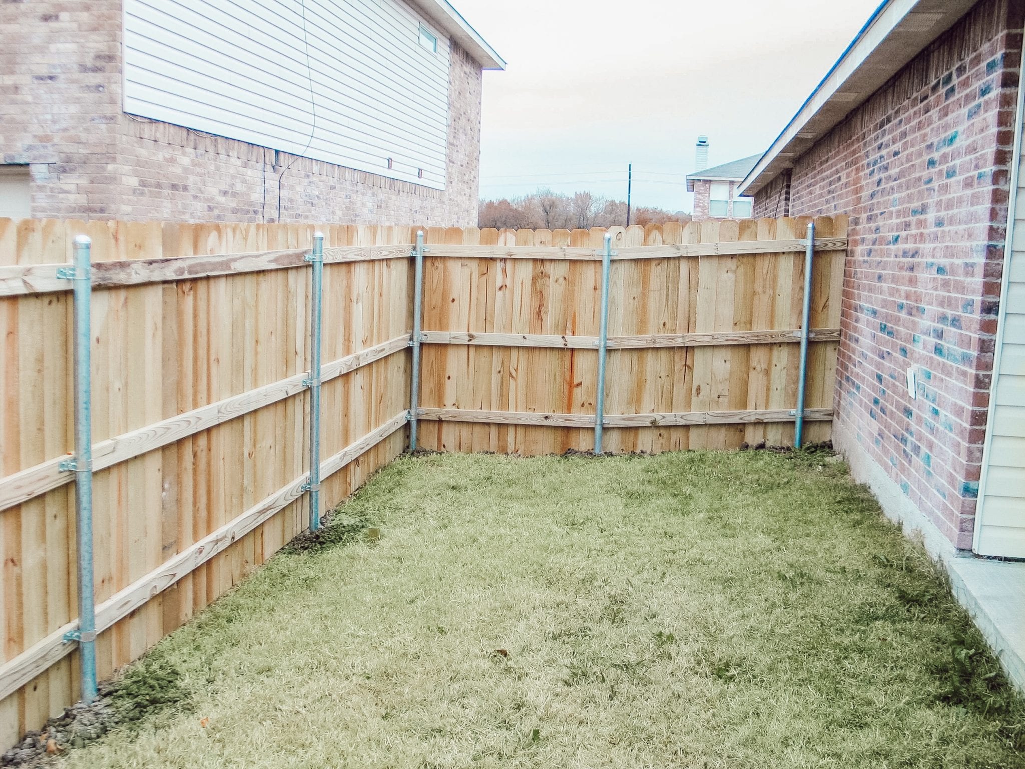 fence on corner of house in greenville, tx