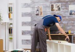 furniture-assembly-worker-standing-reading-instruction-using-tape-measure-worker-tools