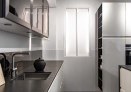 Kitchen interior in a minimalistic design and style with steel metal elements.