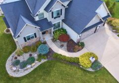 Image of View of outside of traditional american house with beautiful summer landscaping